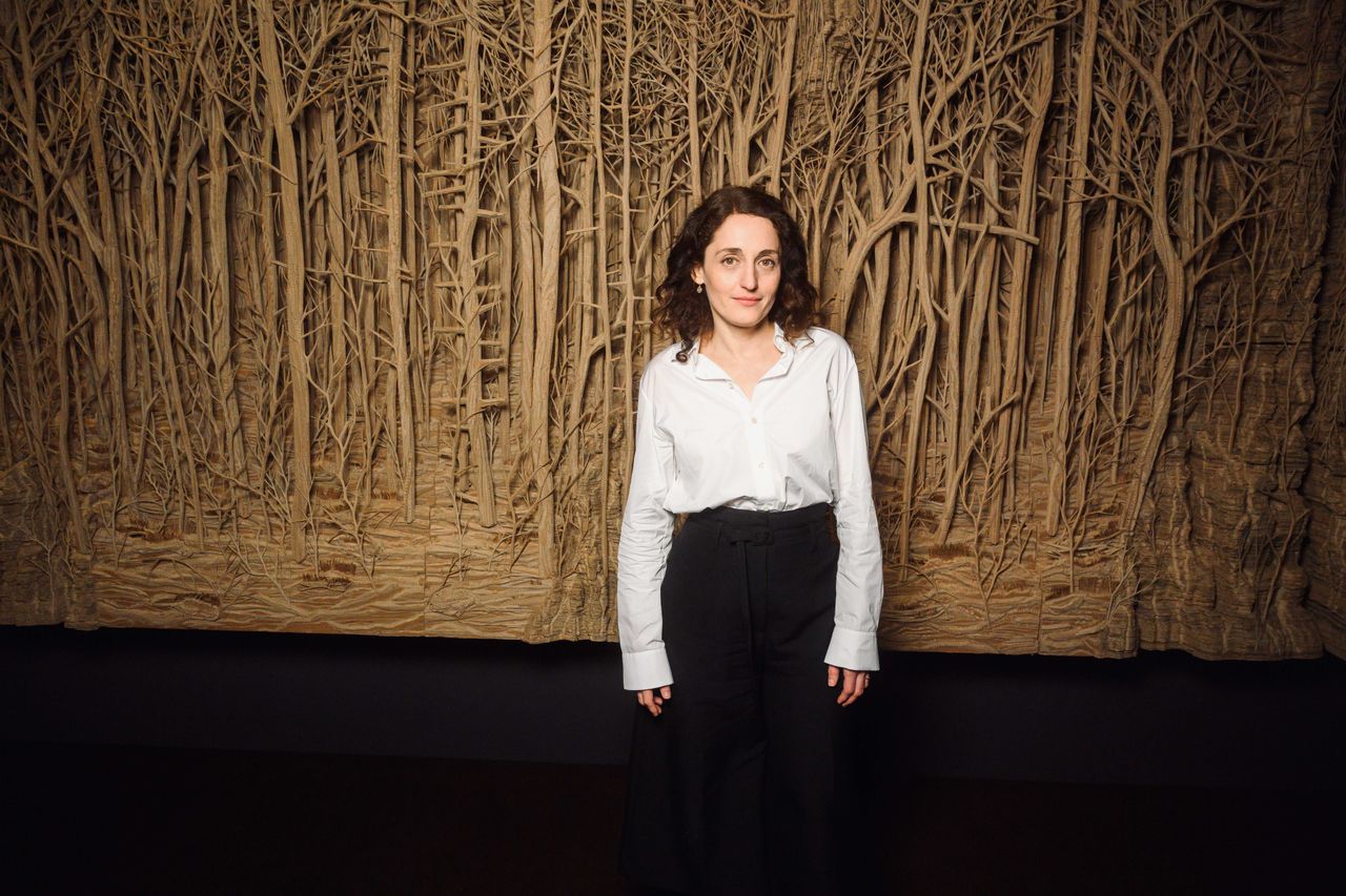 Eva Jospin in front of cardboard installation PROMENADE(S) for Ruinart