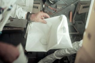 The Apollo 11 "McDivitt purse" seen in Buzz Aldrin's hand as he, Neil Armstrong and Michael Collins flew to the moon in 1969.