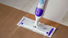 A Swiffer PowerMop being used on a wooden floor