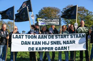 Toon Aerts supporters hold up a banner reading 'Let Toon start so he can go to the hairdresser quickly'