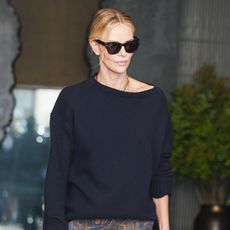 Charlize Theron wearing a navy sweater