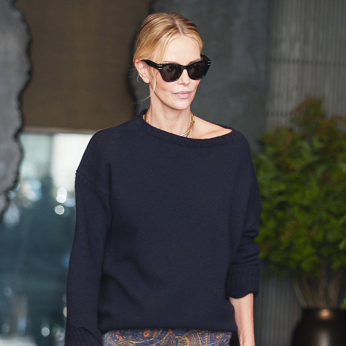 Charlize Theron wearing a navy sweater