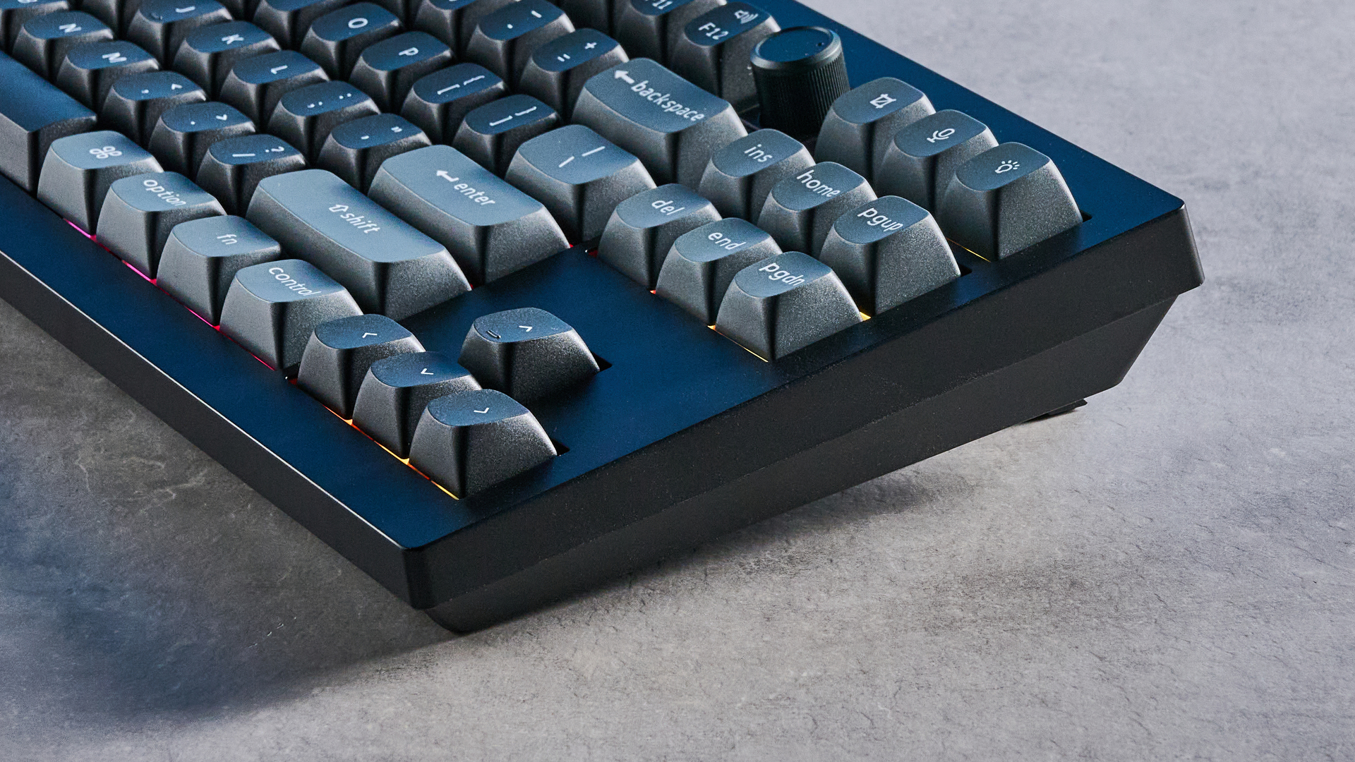 Keychron V3 Ultra 8K photographed on a grey table top in front of a blue background