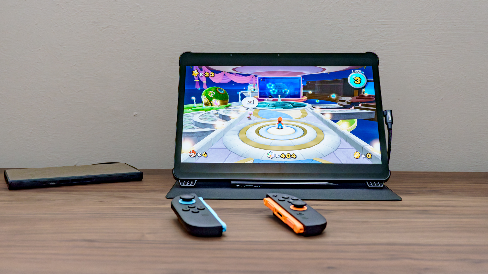 A Nintendo Switch 2 connected to a TCL NXTPAPER 14 using the Genki Covert Dock 3 and Genki ShadowCast 3 Pro