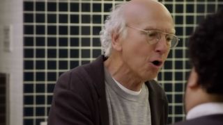 Larry David is looking very angry in a bathroom in Curb Your Enthusiasm