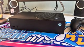 The Xbox Series S 1TB console on a colorful desk mat.