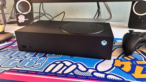 The Xbox Series S 1TB console on a colorful desk mat.