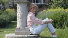 Diana, Princess Of Wales sits with her back against the sun dial at Highgrove House