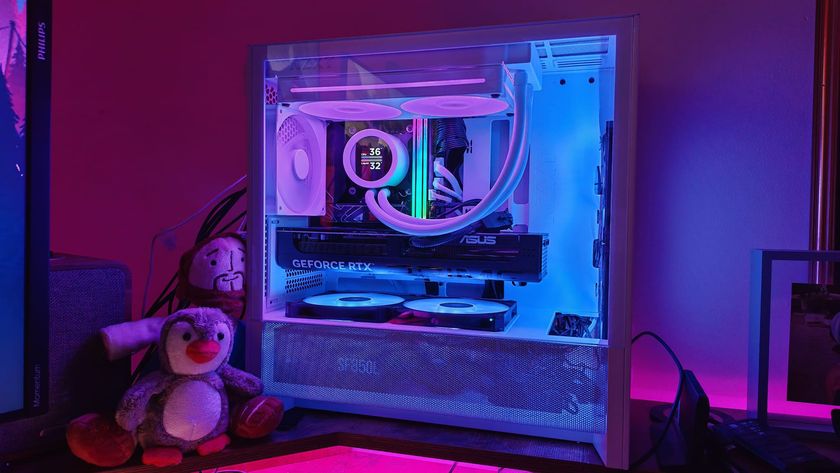A small-form-factor build inside the NZXT H3 Flow showing blue and pink lighting