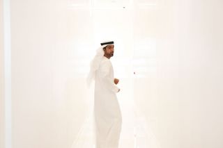 a man in a white room dressed in white