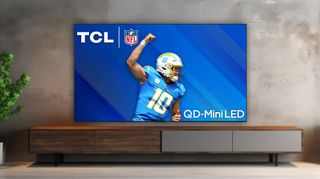 TCL QM89 in living room environment showing football