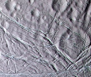 Cassini color image of "snowy" landscape of Enceladus. This terrain lies north of the geologically active south polar ridges and features a rolling terrain crosscut by narrow fractures.