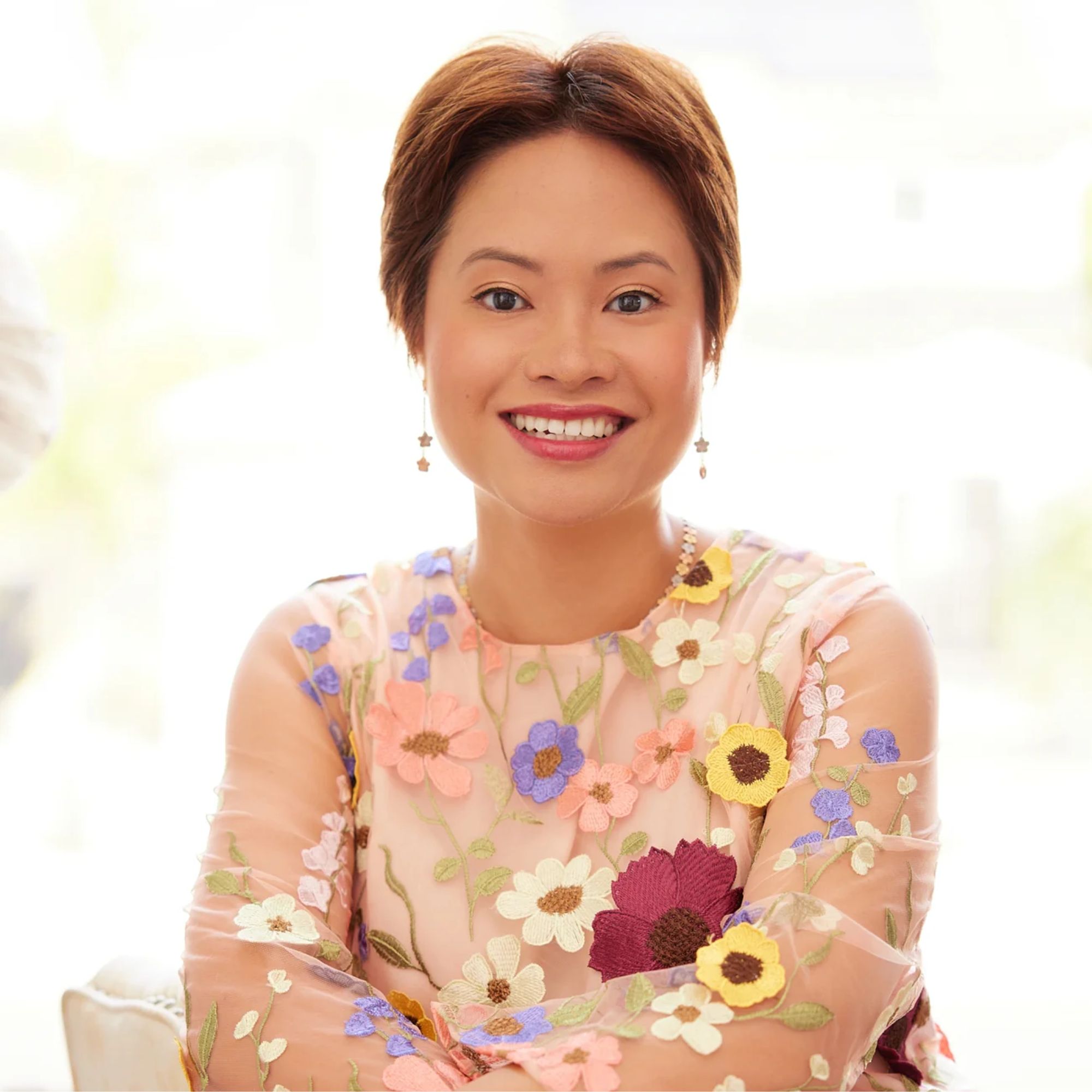 A headshot of Helen Ye Plehn wearing a floral dress