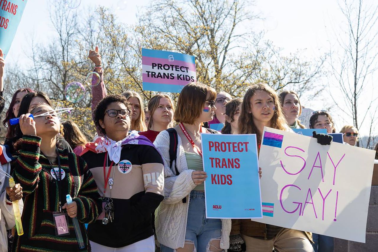 Teenagers holding signs in support of trans kids in Kentucky