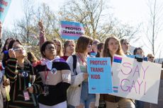 Teenagers holding signs in support of trans kids in Kentucky