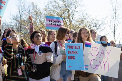 Teenagers holding signs in support of trans kids in Kentucky