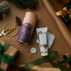 Liz Earle beauty products on a festive wrapping paper background