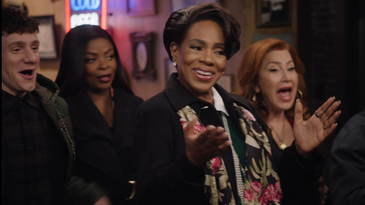 Sheryl Lee Ralph, Chris Perfetti, Janelle James, and Lisa Ann Walter clapping and looking confused in Paddy's Pub in It's Always Sunny in Philadelphia.
