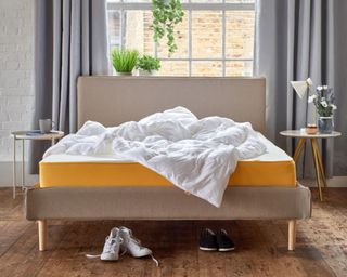 Eve yellow trim duvet on beige bedframe in bedroom with duvet on