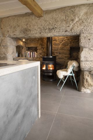 stone inglenook fireplace in stone cottage