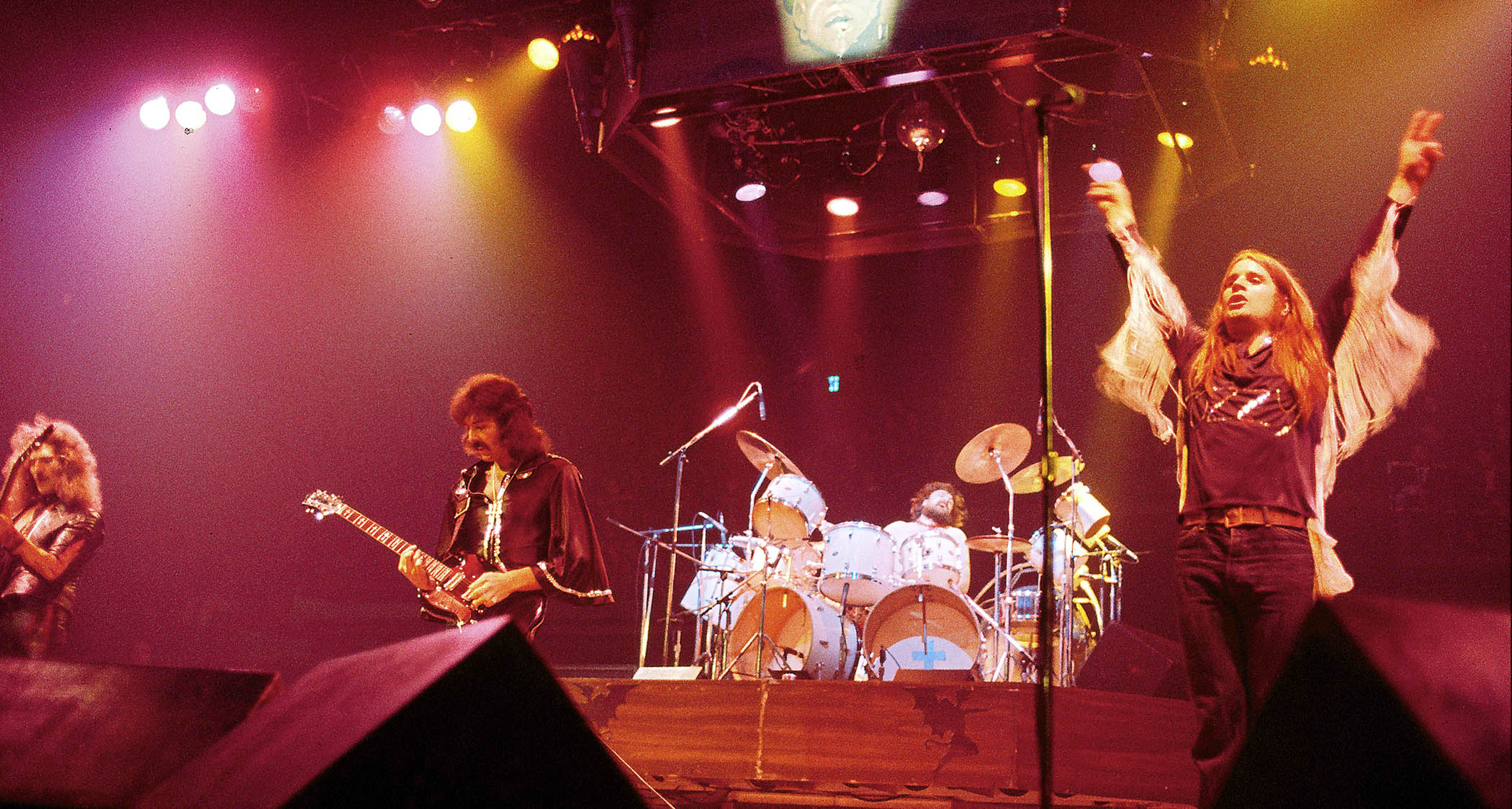Black Sabbath perform at Madison Square Garden, with Ozzy Osbourne working the crowd with his hands in the air.