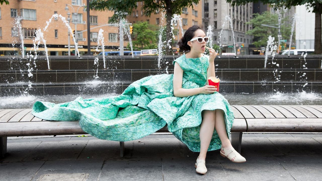 Wearing Gown Whilst Sitting on Bench Eating McDonalds Chips