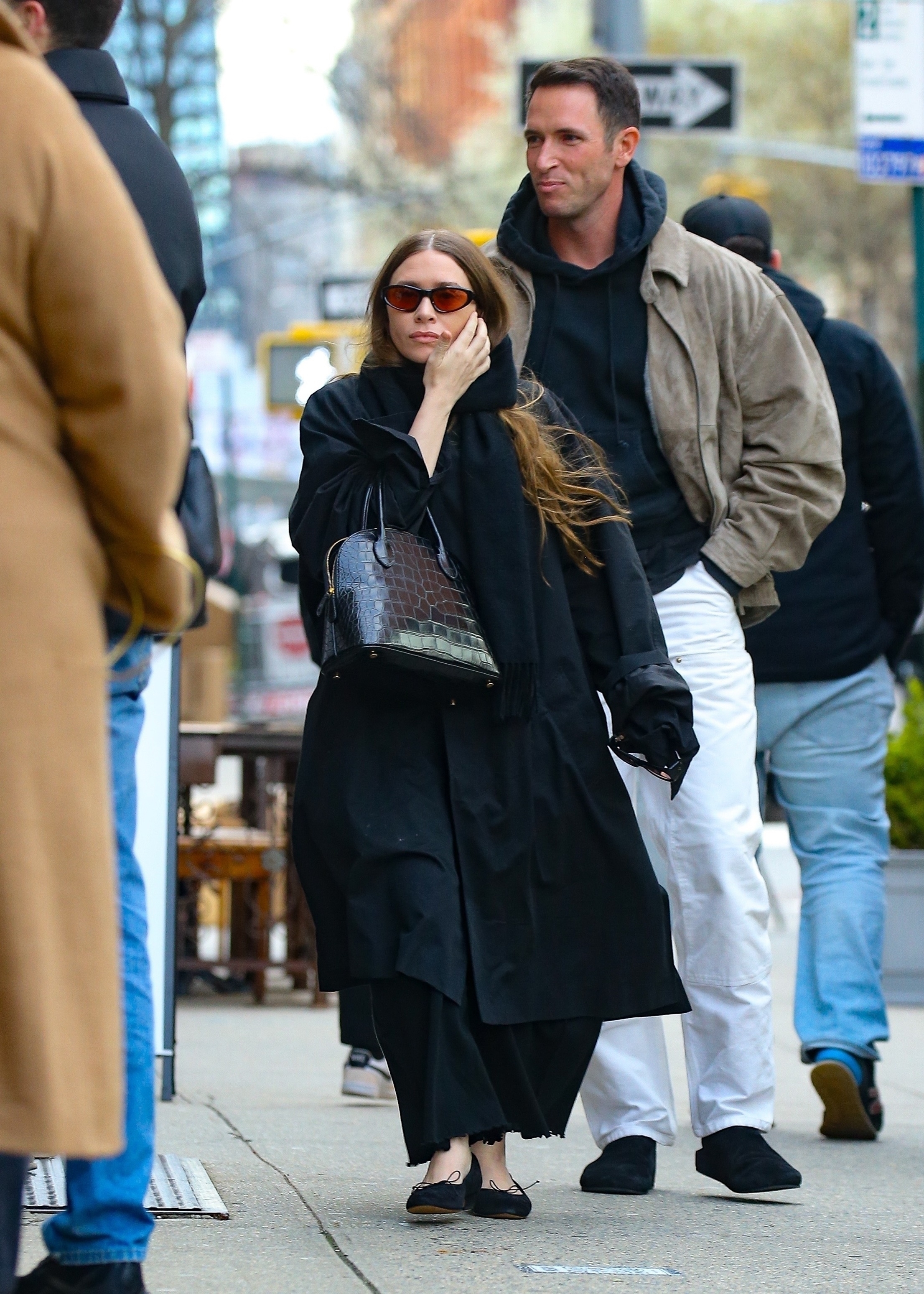 Ashley Olsen, in an all-black outfit and The Row Lady Bag, and Nicolas Turko walking in New York City