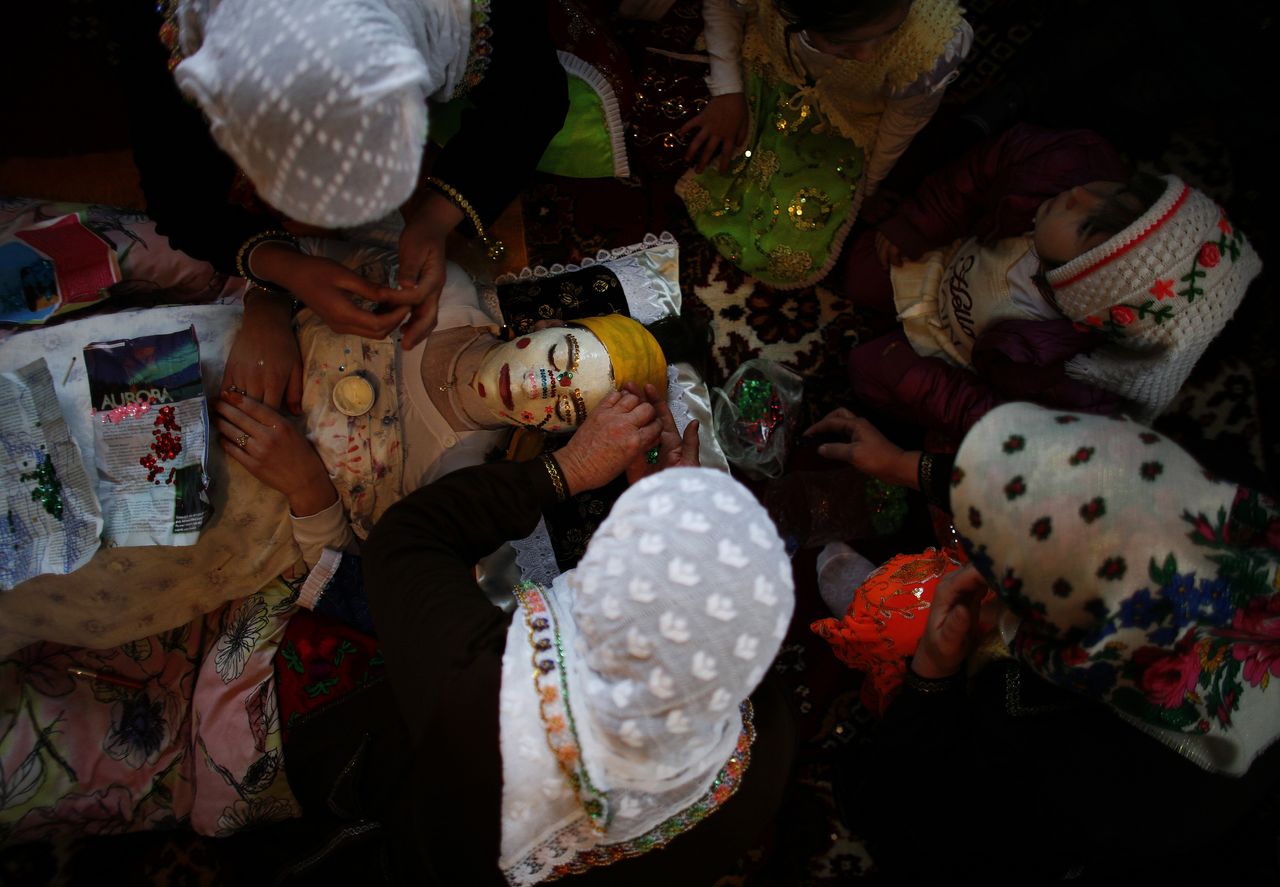 Bulgarian Muslim bride Fatme Kichukova (C) has her make-up applied during her wedding ceremony in the village of Ribnovo.