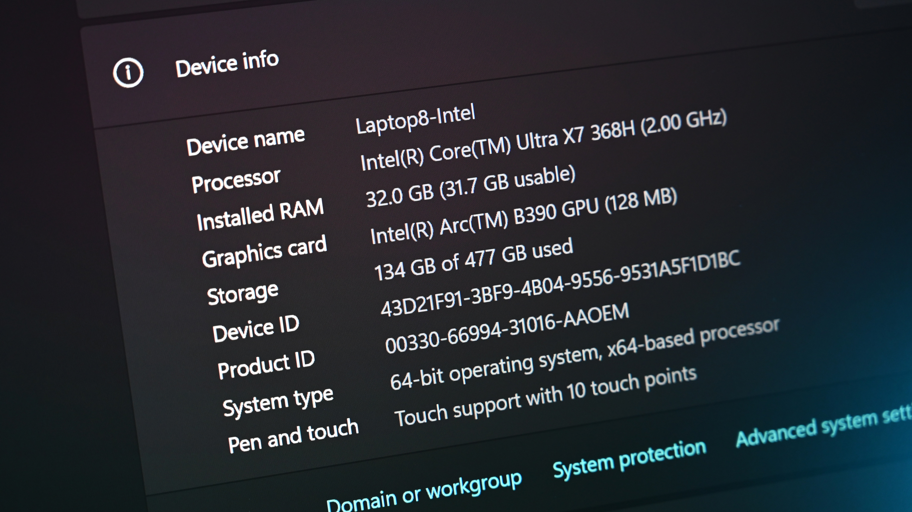 A close-up of a computer system information screen, displaying details like device name, processor type, RAM, graphics card, and storage used. Dark background, sleek and technical tone.