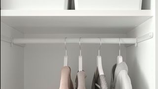 Internal shot of a closet with adjustable hanging rails to demostrate how to organize a small closet with lots of clothes