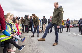 KIRKWALL, SCOTLAND - MAY 25: Prince William, Duke of Cambridge compares shoes with local nursery school children at Kirkwall Marina after a visit to the European Marine Energy Centre on May 25, 2021 in Kirkwall, Orkney, Scotland. (Photo by Jane Barlow - WPA Pool/Getty Images)