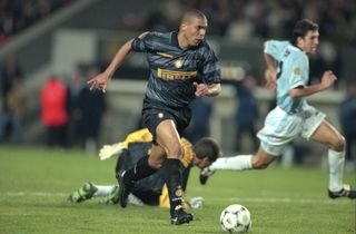 Inter's Ronaldo takes the ball past Lazio's Luca Marchegiani before scoring in the 1998 UEFA Cup final.