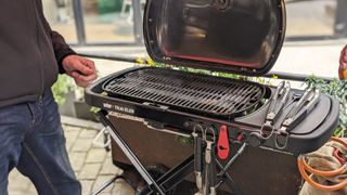 Weber Traveller Compact Portable Gas Grill being used by writer