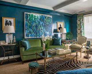Teal living room with green armchairs and large scale feature wall art