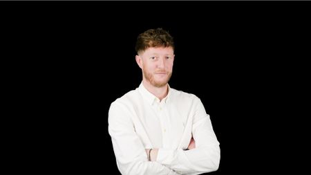 Headshot showing TP-Link distribution channel director for UK&I, Kieran Vineer, with arms folded against a black background.