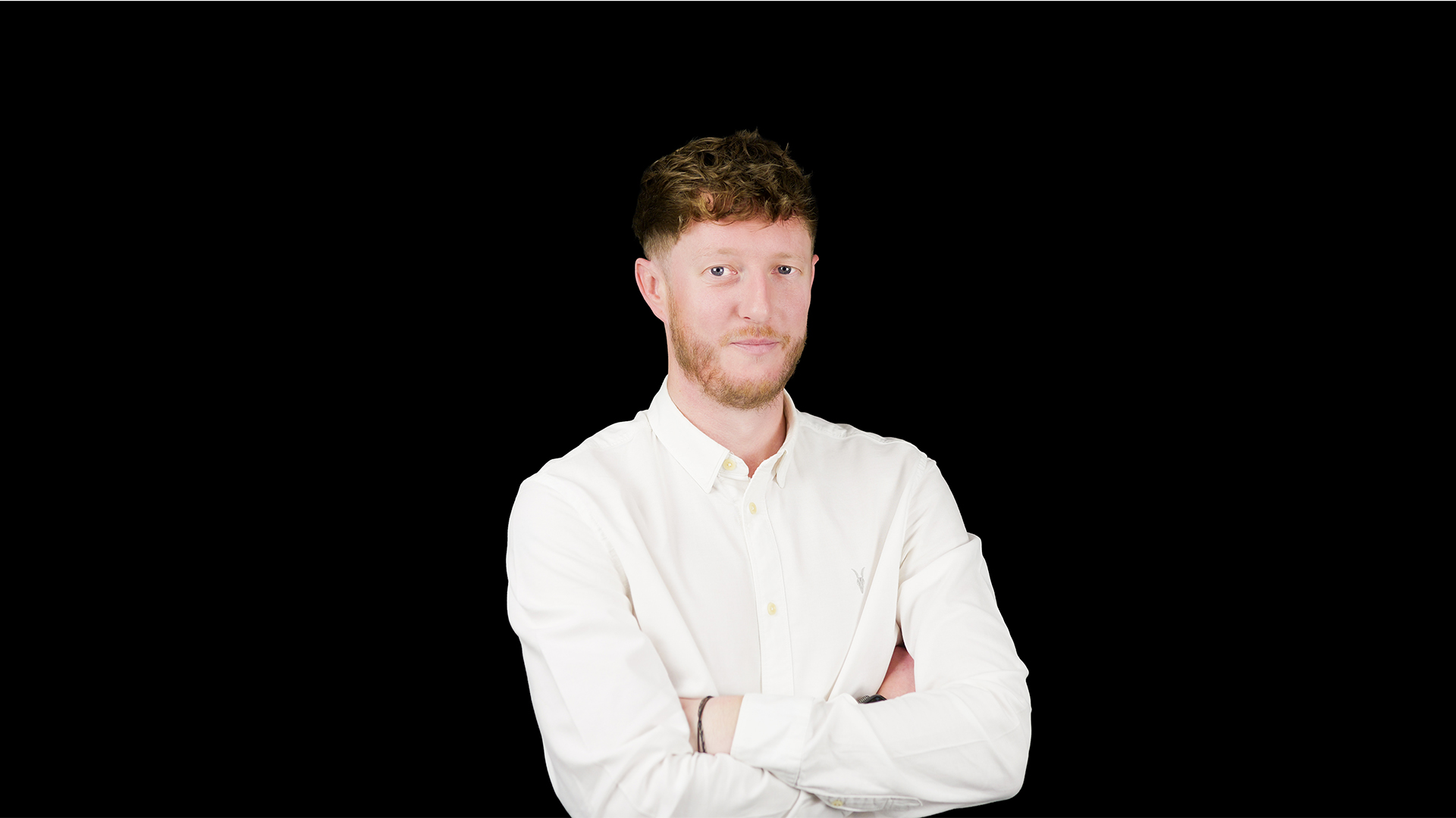 Headshot showing TP-Link distribution channel director for UK&I, Kieran Vineer, with arms folded against a black background.
