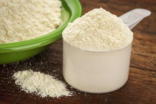 Whey protein powder in a measuring cup