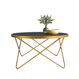 A gold coffee table with flowers on top