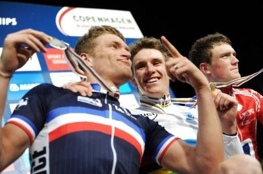 Teammates Adrien Petit, left, and newly crowned world champion Arnaud Demare celebrate on the podium.