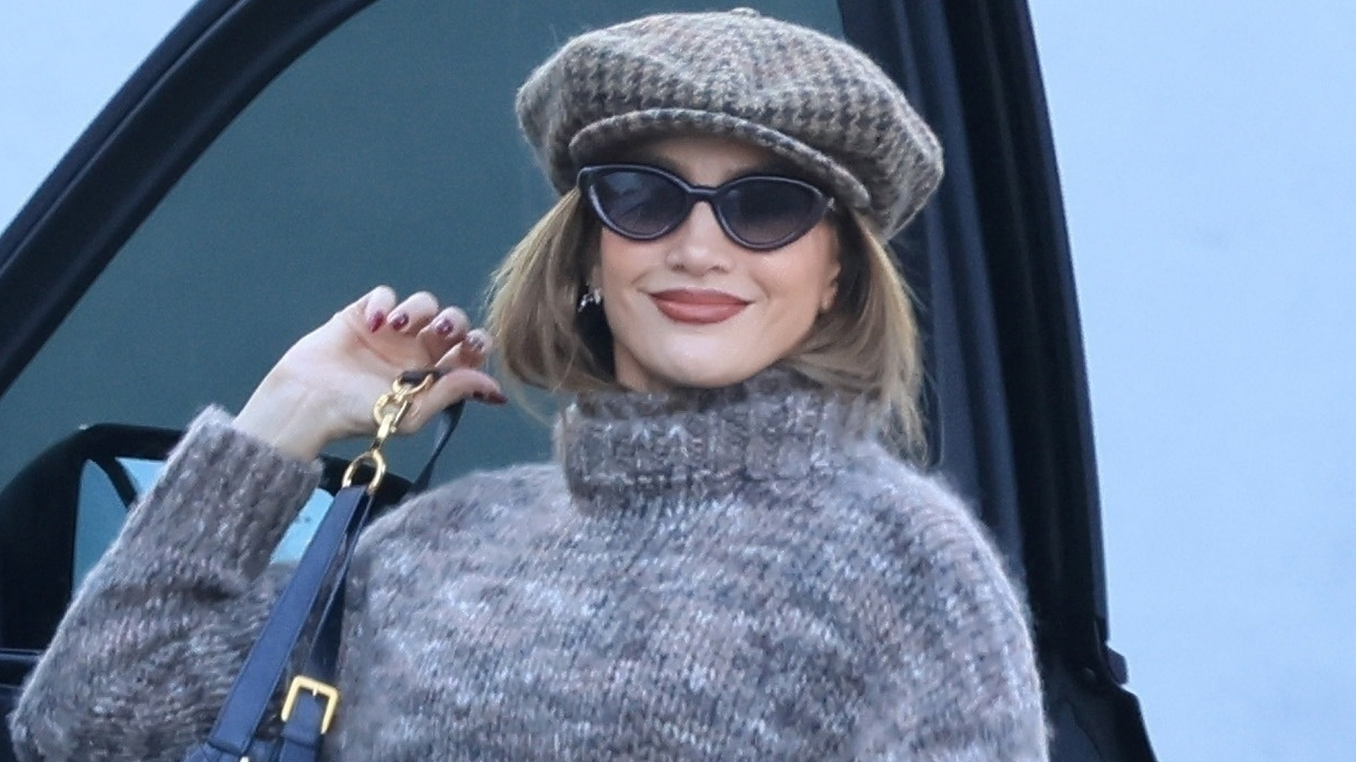 Jennifer Lopez elevated a brown pair of leggings with a cropped sweater, a newsboy cap, and her favorite Dior D-Journey bag