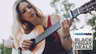 Image of woman playing acoustic guitar with capo