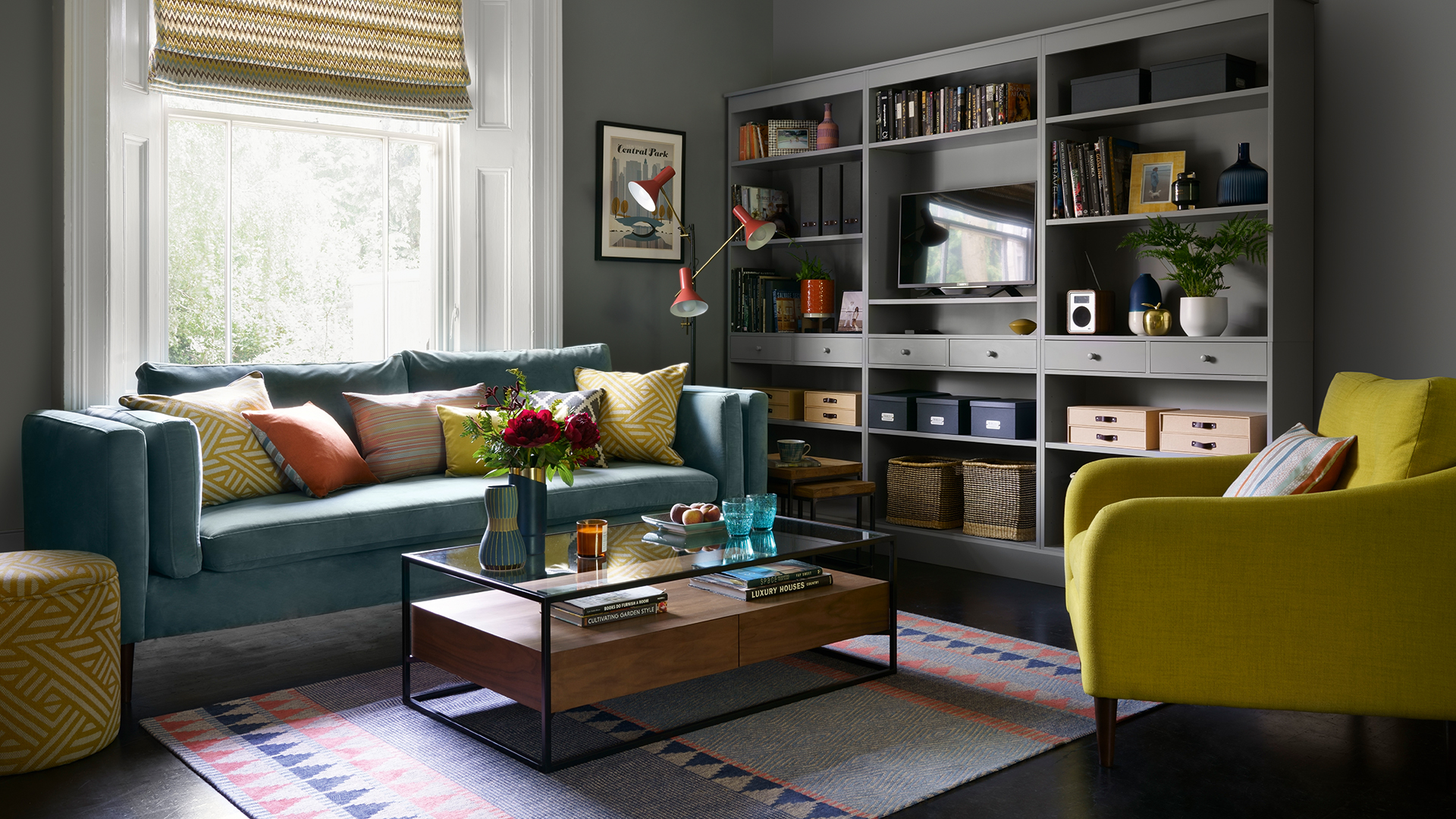 cosy dark grey living room with a teal sofa lime green armchair and bespoke built-in shelves