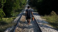 A man walks along the train track that is part of the Interoceanic Corridor of the Isthmus of Tehuantepec