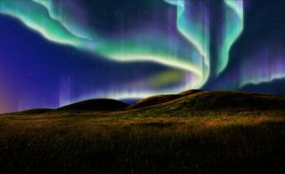 The Northern Lights light up the sky before sunrise.