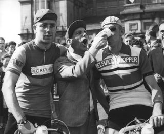 Comedian Norman Wisdom feeds milk to Sid Wilson (North Mids team) prior to starting the race. Wilson went on to become the Welsh Road Race champion the following year.