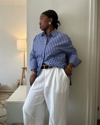 A woman wearing linen pants with a striped shirt