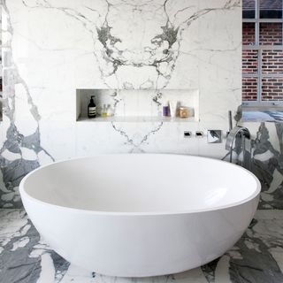 bathroom with marble tiled walls and basin