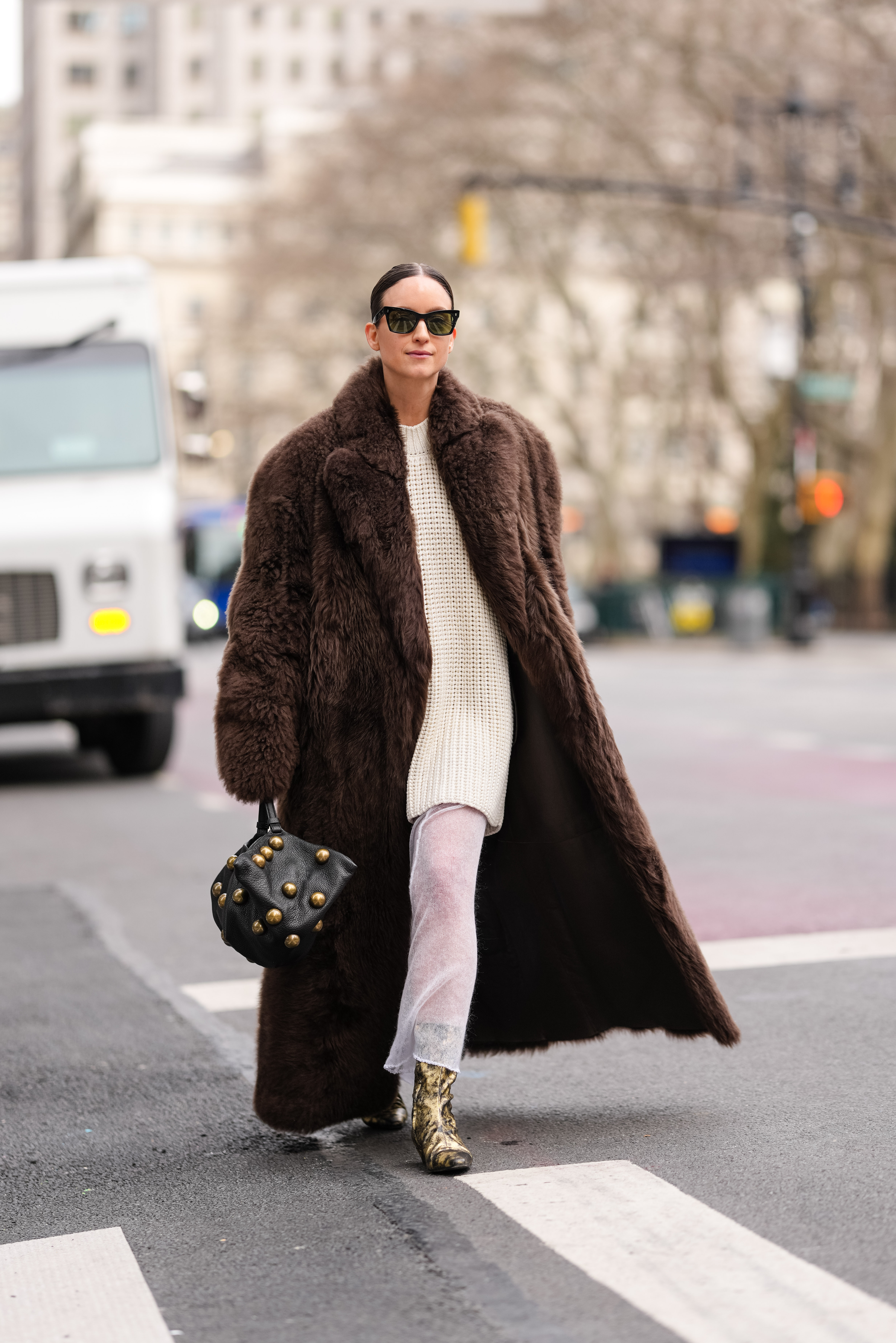 An image of an attended at NYFW wearing the studded bag trend.