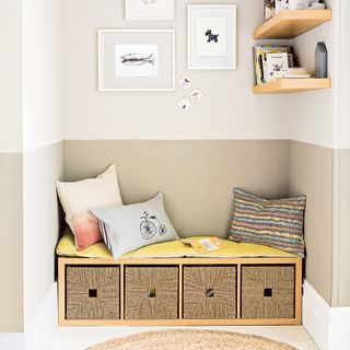 Bench seating with storage surrounded by walls painted half white, half beige
