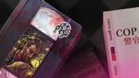 A videotape with an image of a disheveled man, next to a folder containing the word 'COP' and Chinese characters.